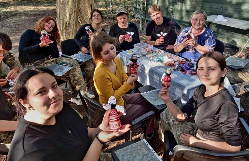Учасники навчально-тренувального курсу демонструють ляльки-мотанки, виготовлені під час творчого майстер-класу.