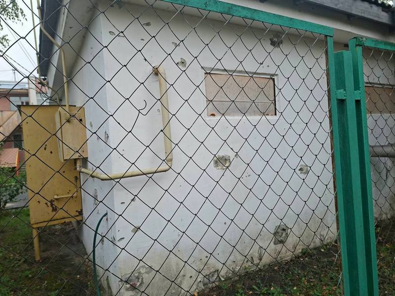 Посічена уламками стіна будівлі котельні дитячого садка за сітчастою огорожею